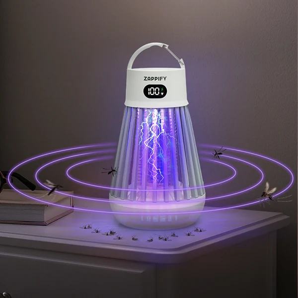 White portable bug zapper glowing purple on a bedside table